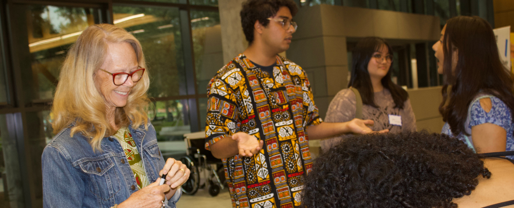 Dr. Doone and Suahs Das speak to students about the Ghana service trip.