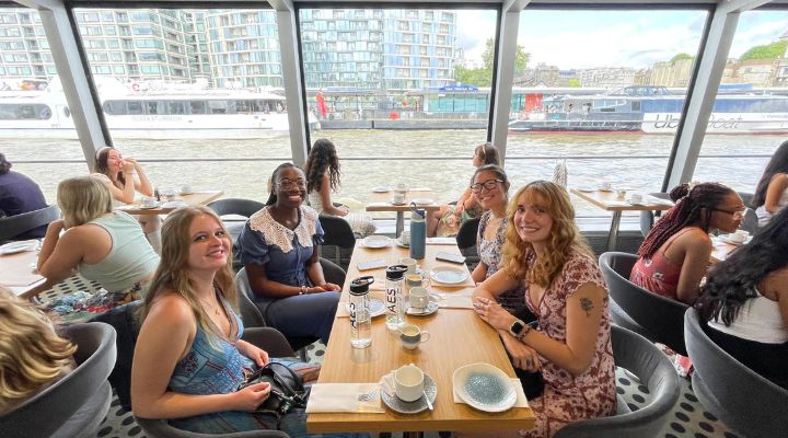 Honors students drinking tea on a boat on the river Thames