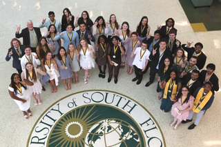 A group of recent graduates pose for the camera