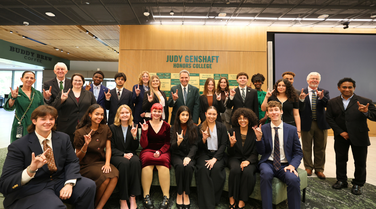 group photo fo Wilcox scholars, Kate Ashmore, Ralph Wilcox, Clara Villanueva, Dean Charles Adams. Sayan Basu, and USF President Moez Limayem in Judy Genshaft Honors College building