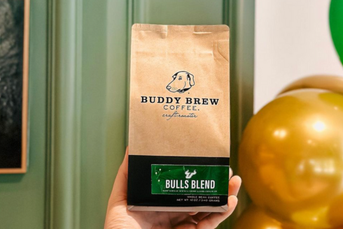 A hand holding up a package of the new Bulls Blend coffee.