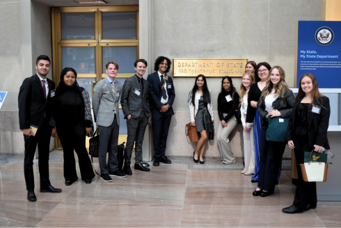 A group of Judy Genshaft Honors College students pose outside of the U.S. State Department in Washington, D.C.
