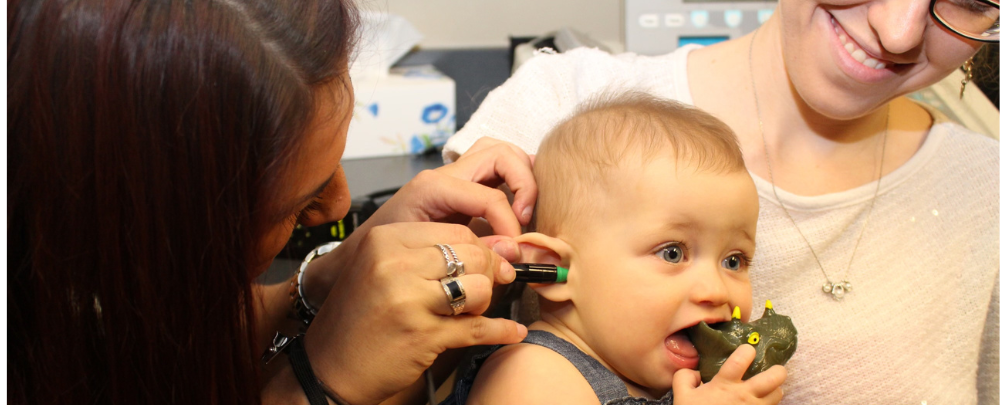 Ashley Hinton performs an ear exam on a small child. 