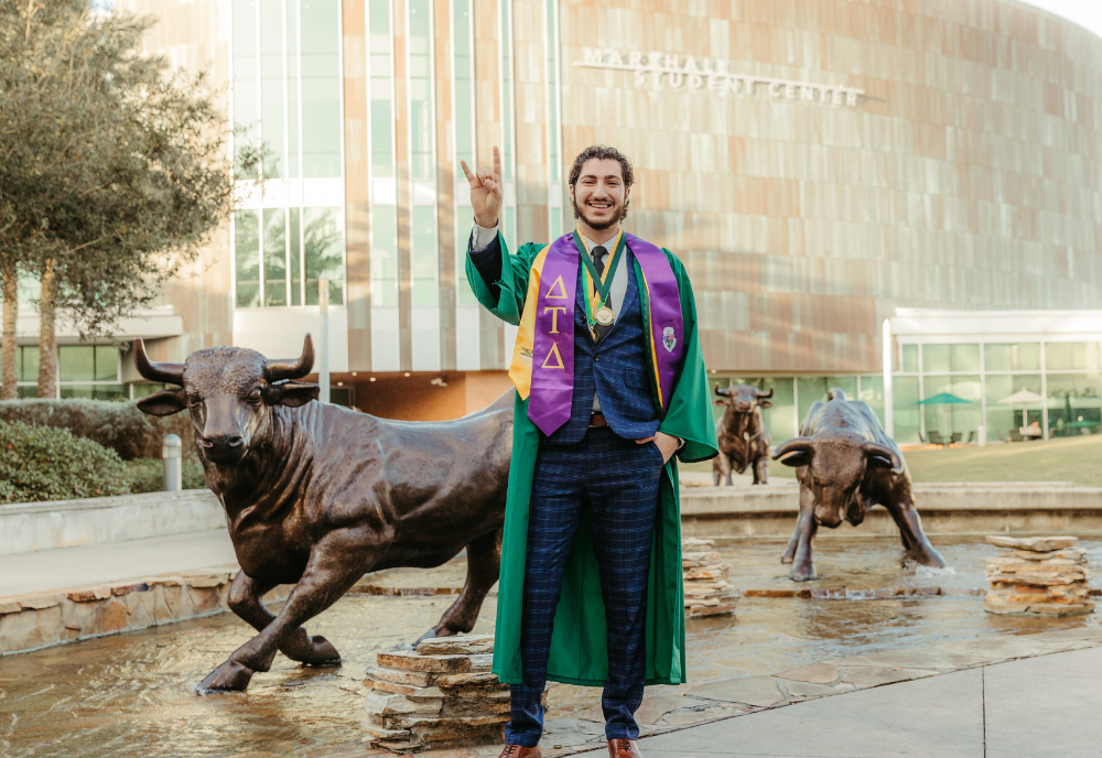 Judy Genshaft Honors College alum Ryan Shargo poses in front of the USF Marshall Student Center