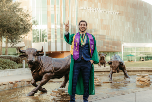 Judy Genshaft Honors College alum Ryan Shargo poses in front of the USF Marshall Student Center