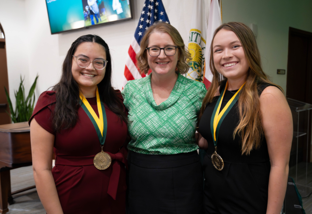 Sarasota-Manatee Judy Genshaft Honors College Assistant Dean Cayla Lanier and two 2023 Honors graduates. 