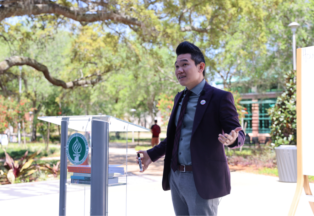 USF Professor Andrew Hargrove shares his lecture "How to Save a Planet" outside of the Judy Genshaft Honors College 