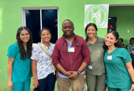 Honors students smile with Dr. Reginald Kerolle