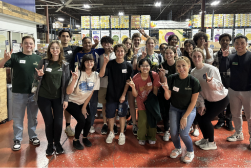 USF Honors students pose for a large group photo at local nonprofit organization Feeding Tampa Bay. 