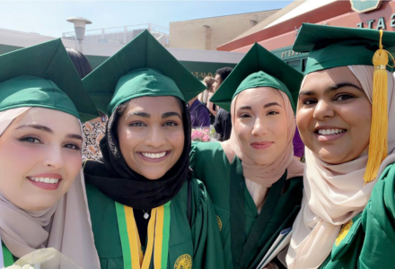 Sana Baban wears her graduation cap and gown with friends