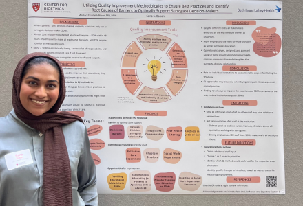 Sana stands in front of her research poster at a conference