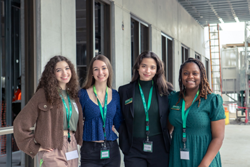 USF Sarasota-Manatee students smile outside of the new residence halls. 