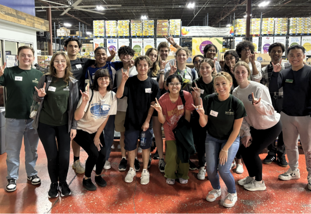 USF Honors students pose for a large group photo at local nonprofit organization Feeding Tampa Bay. 
