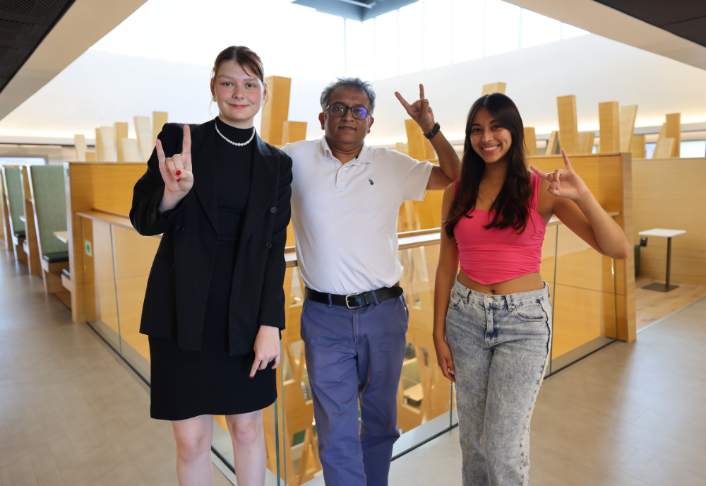 Honors affiliate faculty member Deepak Singh poses with Honors students Amelie McLeod and Daniella Charco in the Judy Genshaft Honors College