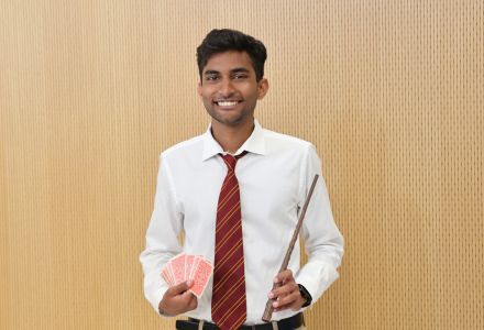 Winner Chad Hosein posing with a deck of cards and magic wand.