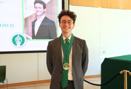 Aidan Jaskolka-Brown receiving his Honors medallion in the Judy Genshaft Honors College building