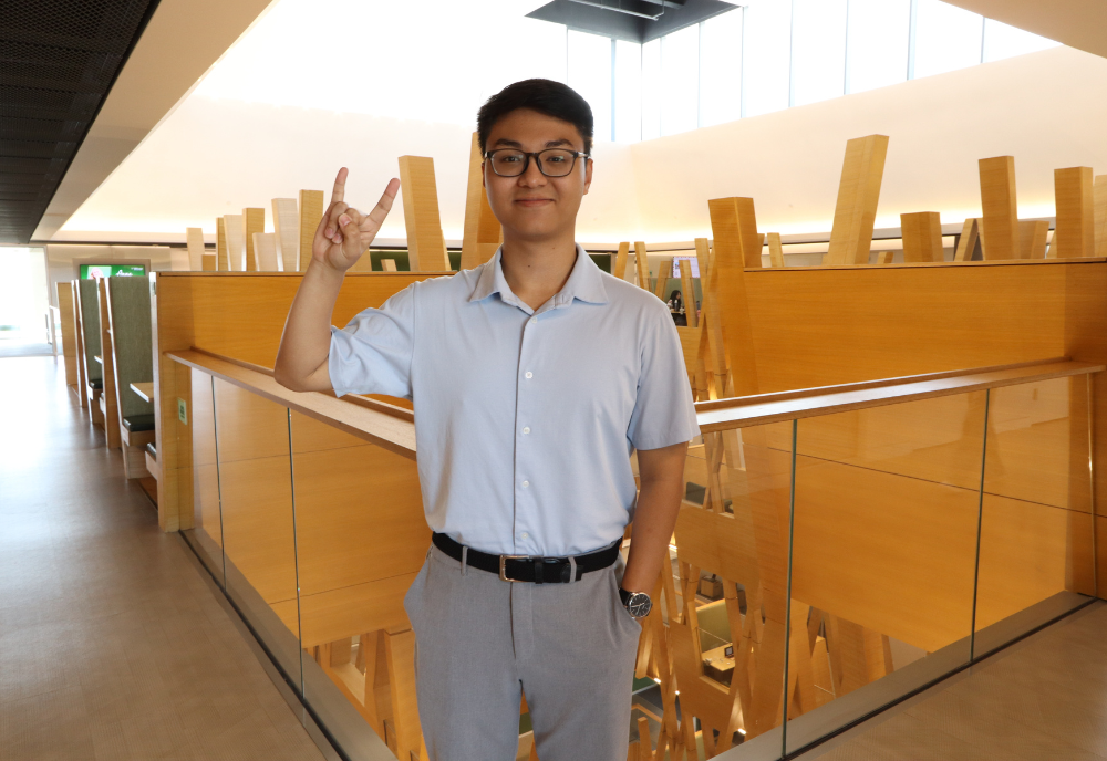 Alex Vu poses inside the Judy Genshaft Honors College