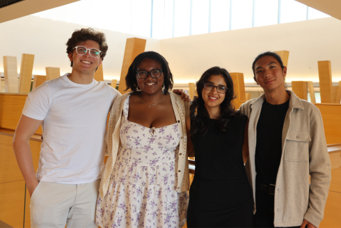 USF Honors students Ghali Omar Boutaib, Catherine Ugwu, Serena Bhaskar, and Rysun Chu smile on pose inside the Judy Genshaft Honors College building.