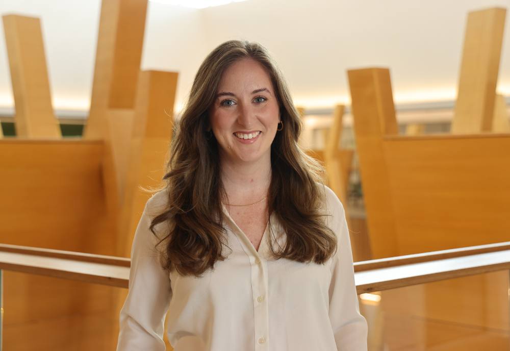 2025 USF Outstanding Young Alumni recipient Dr. Bailee Olliff poses in the Judy Genshaft Honors College building