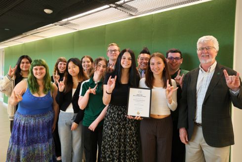 USF Climate Teach-In student leaders, Honors College supervisor Dr. Andrew Hargrove, and Dean Adams pose with the framed CASE award in the Honors building