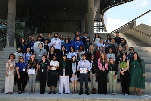 Participants from the 2025 Florida Lessons From Abroad Conference pose for a group photo outside of the Judy Genshaft Honors College building.