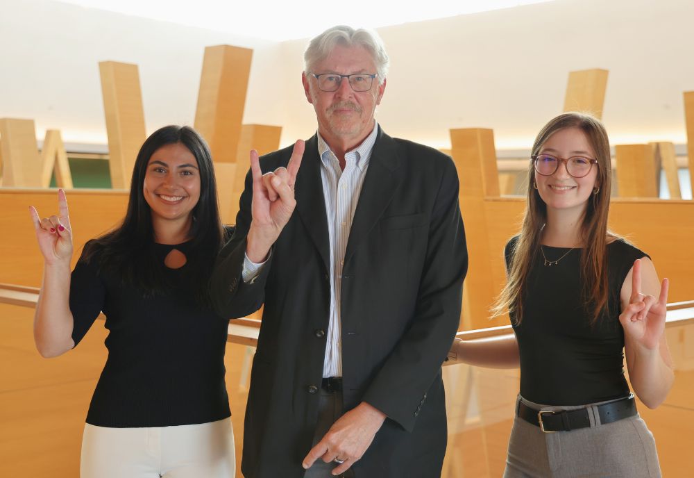 Alison Frate, Dr. Gregory Smogard, and Abigail Brake show their bull pride on the fifth floor of the Honors building, overlooking the atrium. 