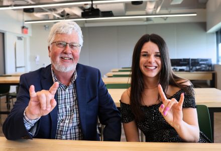 Dean Adams and Grace Beck pose in the Honors Food and Culture studio, showing their bull pride