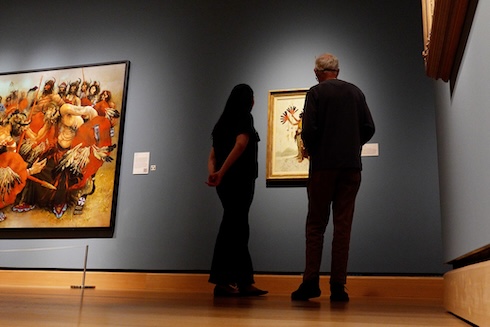 Two people looking at art in a museum