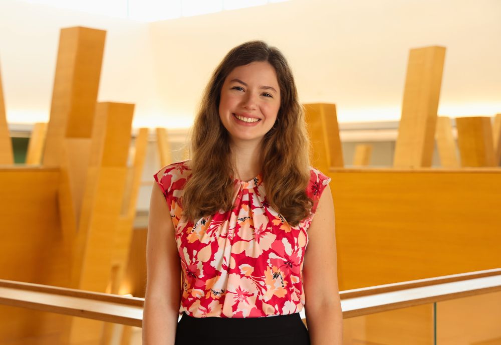 Heather Stroup poses on the 5th floor of the Judy Genshaft Honors College building.