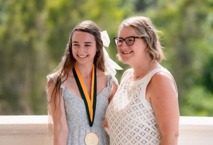 Isabelle Sorenson posing at graduation with Dr. Cayla Lanier