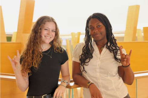 Kelsey Sherman and Elise Prophete pose in the Honors building with the