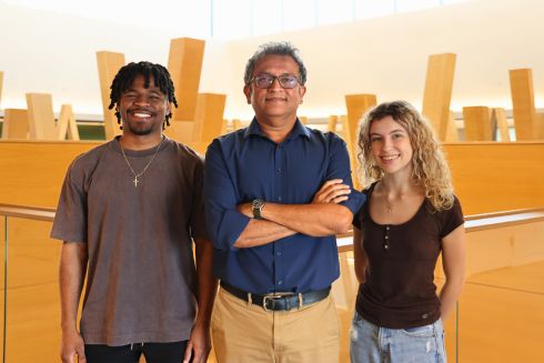 Daniel Anderson, Professor Deepak Singh, and Jenna Epright pose together on the fifth floor of the Honors building.
