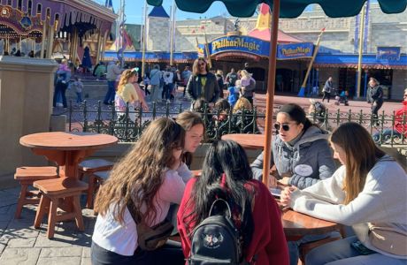 A group of LLC students meet to discuss their theme park design in Magic Kingdom.