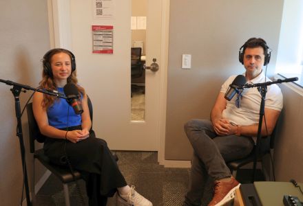 Mira Stimac and Frank Nunez sit in the Honors AV room, listening to a question during the filming of the podcast.