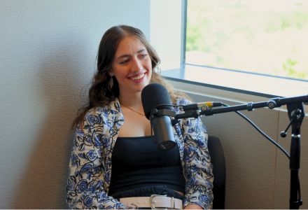 Natalie AmRhein chats on the Honor Roll Podcast in the Audio Production studio by a window.