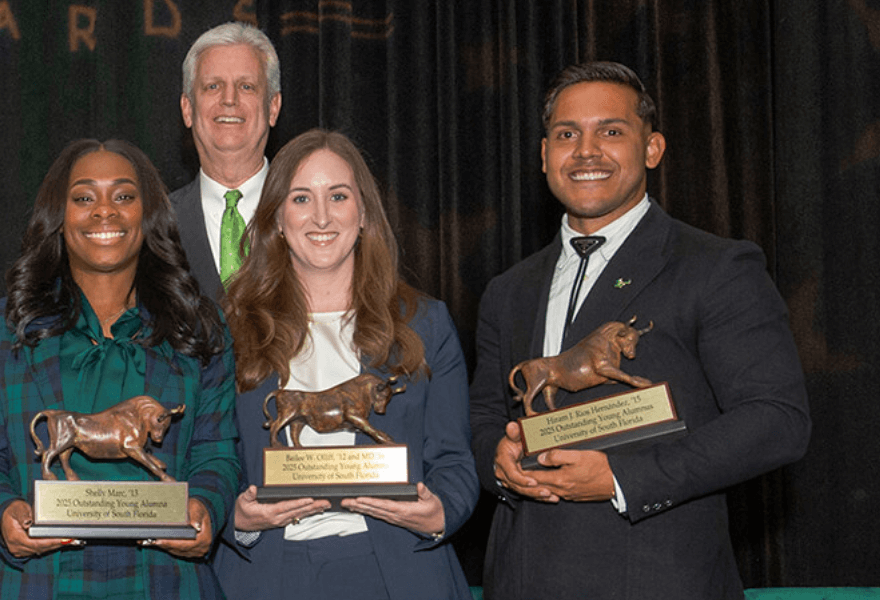 Baillee Oliff and Hiram RIos Hernandez receiving their Outstanding Young Alumni awards