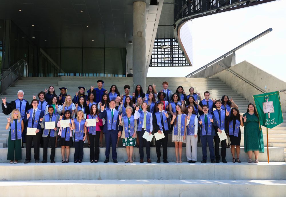 2025 USF Phi Beta Kappa Society inductees pose on the steps of the Judy Genshaft Honors College amphitheater post-induction ceremony. 
