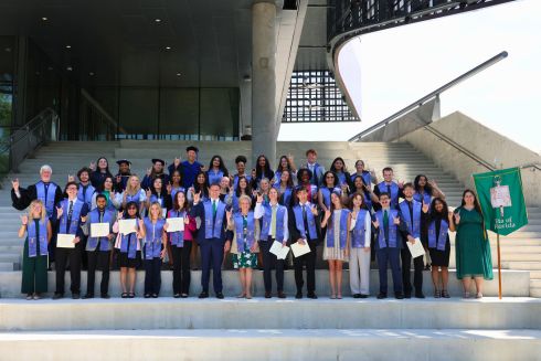 2025 USF Phi Beta Kappa Society inductees pose on the steps of the Judy Genshaft Honors College amphitheater post-induction ceremony.