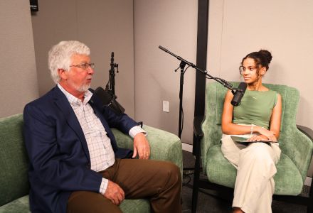 Dean Adams and an Honors student chat in the video podcast room