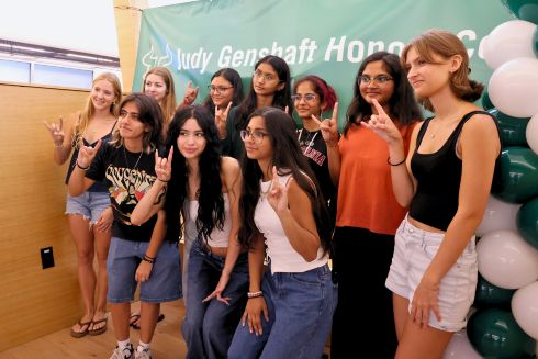 Honors students pose in a fifth floor learning loft with the