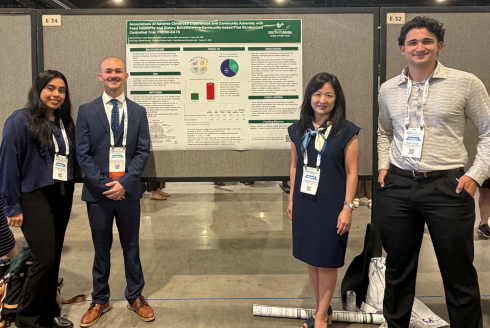Students Ashley Varela, Richard Scalzo, and Ryan Singh standing in front of their research poster alongside Dr. Heewon Gray.