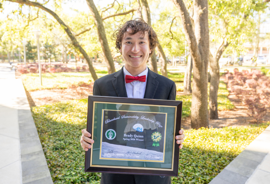 Brady Quinn outside with a certificate