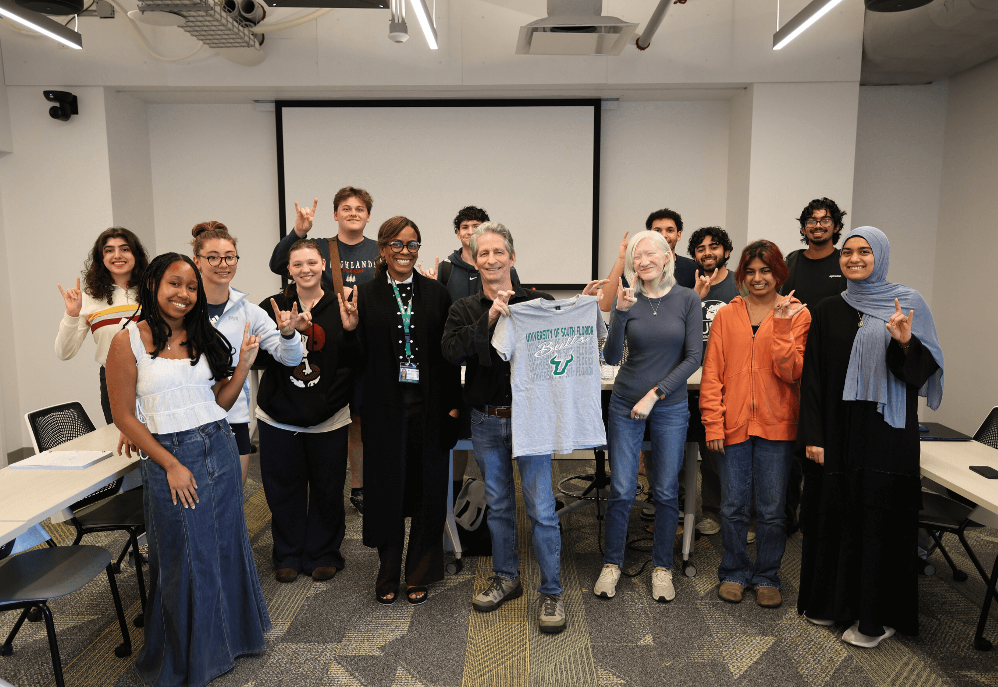 Brian Edgar, Angela Jones, and Honors students pose after class with a USF t-shirt