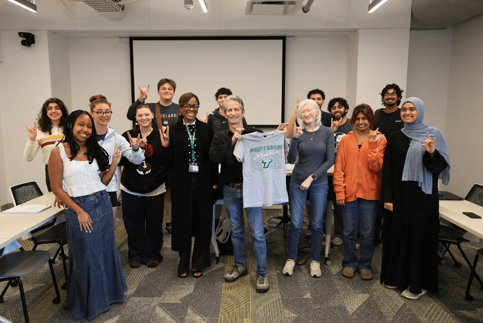 Brian Edgar, Angela Jones, and Honors students pose after class with a USF t-shirt