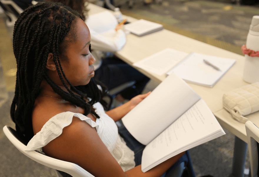 Student reads screenplay in classroom