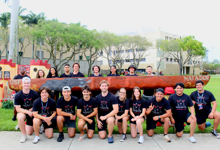 Students kneel in front of and stand behind 2026 USF Concrete Canoe: Matador