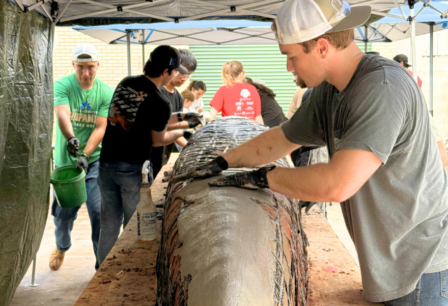 USF students preparing concerete canoe on a table.