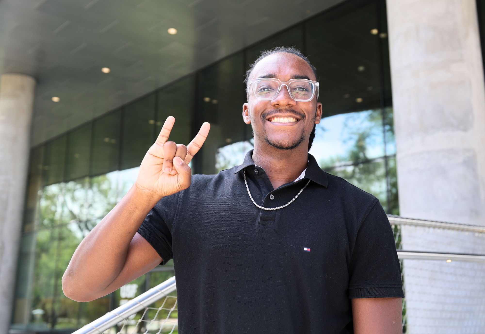 DJ Bernadotte on steps of Judy Genshaft Honors College amphitheater