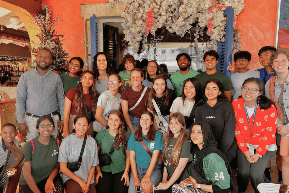 USF Honors students and Dina Martinez Tyson pose with community members in the Dominican Republic
