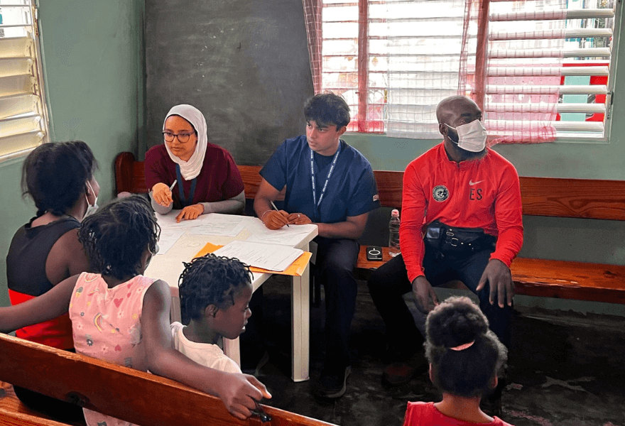 Jumana Ahmed and Kritin Sharma help Dominican Republic residents with paperwork